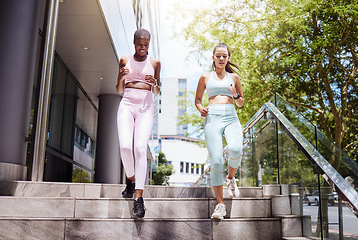 Image showing Fitness, exercise and women friends running on building steps, speed and cardio workout in a city. Wellness, energy and personal trainer showing support and motivation for endurance goal performance