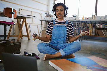 Image showing Painter girl and laptop video call with headphones for concentration and focus in painting class. Artistic Indian woman learning artist paint brush tutorial and technique online in workshop.