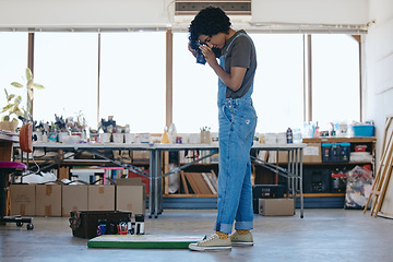 Image showing Creative woman artist in studio with camera, working on art for exhibition, photography for marketing and portfolio. Indian painter in workshop, focus and painting, with paint around canvas.