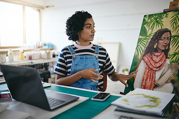 Image showing Art girl and laptop video call in studio for professional remote sale of painting on canvas online. Creative indian woman with focus and concentration selling artwork on the internet in workshop.