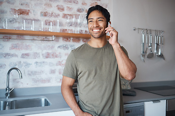 Image showing Happy, smile and man on a phone call in the kitchen of his home talking on technology for communication. Happiness, young and man from colombia having mobile conversation on a smartphone in his house