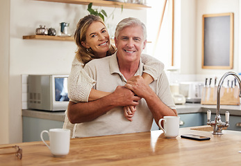 Image showing Senior couple, smile and love while hugging in kitchen drinking coffee, relax and bonding feeling happy, support and trust. Portrait of old Australia man and woman in healthy relationship or marriage