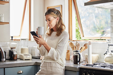Image showing Coffee, phone and senior woman in kitchen browsing social media, text message or online app at home. Relax, tea and reading news or mobile online web surfing with female from Canada on 5g smartphone
