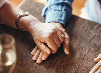 Image showing Holding hands, date and couple with support at restaurant for celebration of love, marriage and anniversary. Man and woman with trust, care and gratitude at a cafe or coffee shop table for dinner