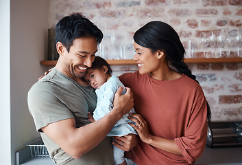 Image showing Down syndrome, happy family and baby in a kitchen, bonding and embracing in their home together. Child development, love and special needs care for disability by asian parents enjoy morning indoors