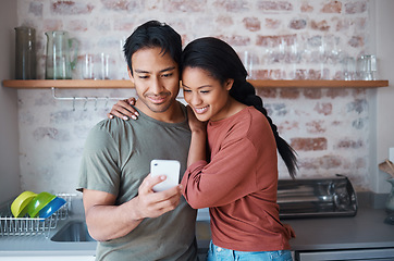 Image showing Couple, smile and phone in kitchen for social media, meme or comic video on web. Man, woman and happy with smartphone while reading funny blog, chat or news on app while relax together in home