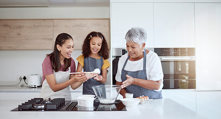 Image showing Women in kitchen teaching girl baking cake or cookies for family. Happy grandmother, mom and young child learning with cooking ingredients in family home make snack, biscuit or flour while have fun