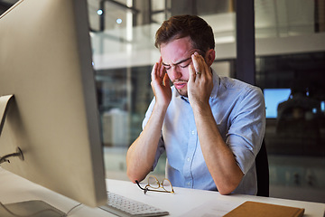 Image showing Stress, depression and mental health for night business man sitting at his computer desk with headache, anxiety and burnout from work pressure. Stressed male working late in his Australia office