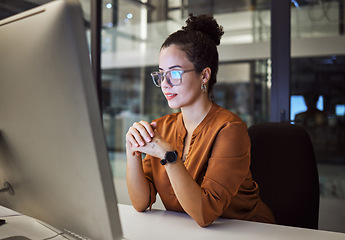 Image showing Night, research and report with a business woman working on a computer in her startup office at night. Thinking, idea and technology with a young female entrepreneur at work on a desktop in a company