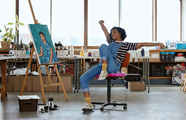 Image showing Art, happy and excited woman with painting in studio or design school smiling at finished creative project. Student from India, painter girl and celebration of completed canvas in classroom on chair.