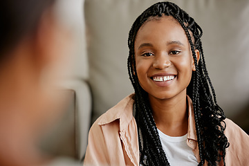 Image showing Happy, black woman and smile of a person on a home couch with happiness and a friend. Female face from Houston on a living room sofa looking at a person in a conversation and listening in a house