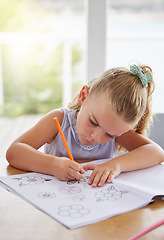 Image showing Education, art and girl learning to draw at a table, having fun with colors and paper sketch in her home. Growth, development and creative activity for young learner looking serious about picture