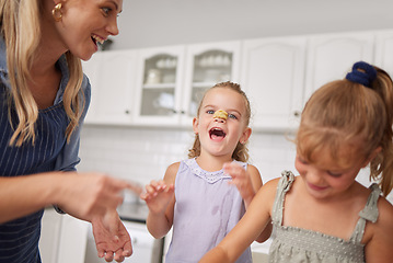 Image showing Home kitchen, children play while cooking with happy mother and funny family time learning to bake. Crazy girl child with flour dough on nose, laugh together helping mom smile and sweet kids have fun