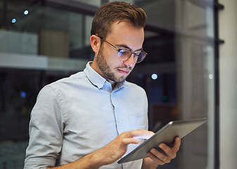 Image showing Man in the office, at night with digital tablet and working overtime. Professional business man in online marketing company, planning corporate strategy and testing new web feature to increase growth