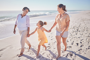 Image showing Family smile at beach, mom and grandmother hold hands with girl child on holiday. Children love vacation by the sea, happy grandma in retirement and walking in sand together as they relax as a group