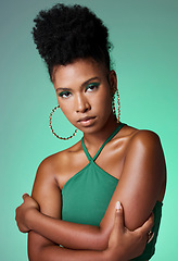 Image showing Fashion, beauty and makeup with a green background and black woman in studio for style and empowerment. Portrait, cosmetics and equality with a confident young female standing arms crossed inside