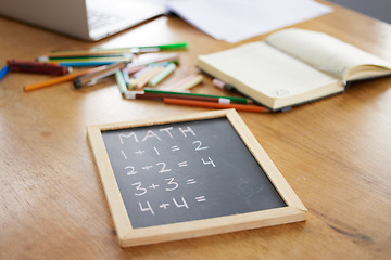 Image showing Chalkboard, math or notebook in homeschool study at house in covid lockdown, quarantine or social distancing. Zoom, education question or learning support for students, children or kids on wood table