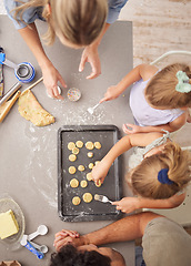 Image showing Baking, family and girl children learning to bake cookies in kitchen at home from above with mom, dad and sister. Man, woman and kids having fun with dough, cooking and food together making pastry