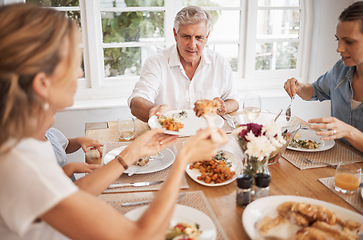 Image showing Family, food and eating with a senior man at the dining room table with his relatives for a meal during a visit or celebration event. Happy, together and fresh with a hungry group of people at home