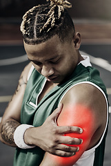 Image showing Fitness, basketball and black man with sports injury in need of first aid or physiotherapy during game. Sportsman from Nigeria with hand on arm, muscle pain and medical emergency on basketball court.