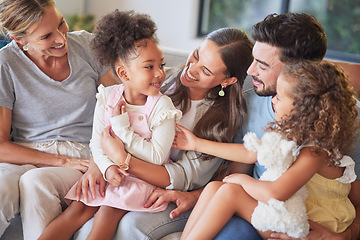 Image showing Love, relax and happy family introduction on sofa, laughing and playing in a living room together. Parents, kids and grandmother talking and enjoying quality time with sweet interracial children