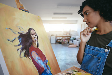 Image showing Creative woman, thinking about her art, and looks at painting in studio for exhibition. Professional Indian painter, artist with paint brush, search for inspiration for work on canvas.