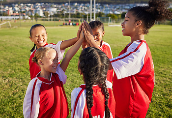 Image showing Children, girl football team and high five for sports group motivation on a soccer field for celebration of goal, winning and teamwork outdoors. Junior competition for kids diversity tournament match