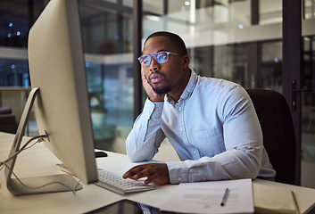 Image showing Tired, burnout businessman on computer at night in a dark office working on company finance management. Sad, mental health and depression corporate accountant with glasses and tax or audit paperwork