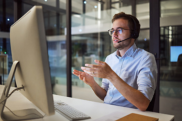 Image showing Man, work and call center in office for telemarketing with pc on desk give support to client in Canada. Crm, working and customer service at company, consultant help client on phone call in Sydney