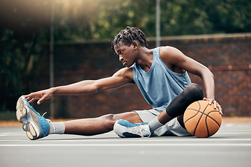 Image showing Man, basketball and training do stretching, exercise or prepare on court with sportswear. Black man, sport and ball before practice match or game in urban park for sports, fitness and physical health