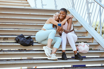 Image showing Fitness, friends and hug with women and phone with gym bag for selfie, social media or internet. Workout, training and exercise with girl on stairs and streaming online for sports, goals and health