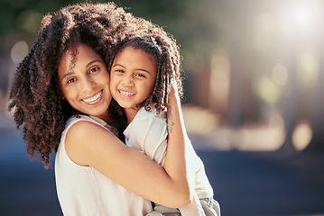 Image showing Black mother with girl child hug in a park with summer lens flare for love, care or growth development outdoor wellness. Happy natural mom bonding with kid in nature portrait together for mothers day