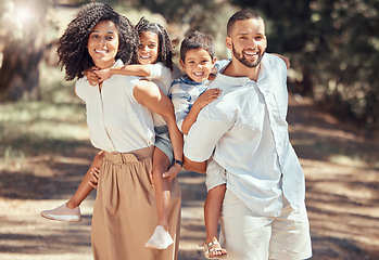 Image showing Portrait of happy family bonding in a park, having fun and being playful on peaceful walk in nature together. Relaxed parents enjoy time with kids and moments of parenthood while showing affection