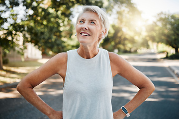 Image showing Fitness senior woman with earphones and smartwatch for her outdoor exercise, listening to music or motivation podcast with 5g technology. Healthy elderly person or runner happy with workout results
