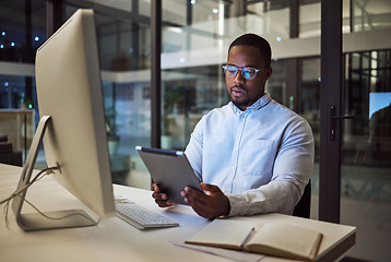 Image showing Black businessman, tablet planning and desktop at night in startup for online ideas, strategy and connect apps on 5g technology in Nigeria. Employee working in dark modern office for internet project