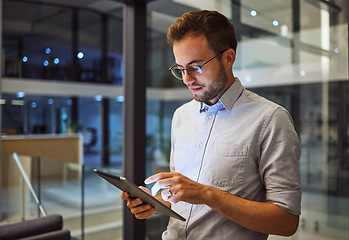 Image showing Man in office, working on tablet at night in the office and testing campaign strategy for marketing company. Dedicated professional employee, working late on project and using technology at business