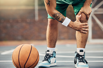 Image showing Basketball, athlete and knee injury on the basketball court during outdoor game or training. Man in with leg pain after sports accident with a broken joint, inflammation or muscle tear during match.