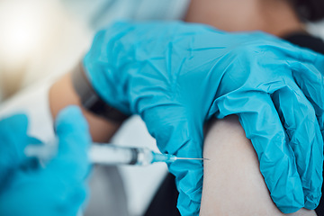 Image showing Vaccine, covid and healthcare with a doctor and patient in the hospital for an injection, treatment or cure. Hands, needle and syringe with a health professional injecting medicine into an arm