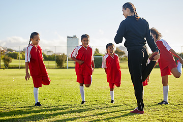 Image showing Team, soccer and girls stretching in football stadium with coach in training, sports and group warm up together. Healthy, teamwork and young school children doing exercise with fitness instructor