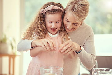 Image showing Children, family and baking with a girl learning and grandmother cooking in a kitchen of their home together. Kids, food and ingredients with a senior woman teaching her granddaughter to make a meal