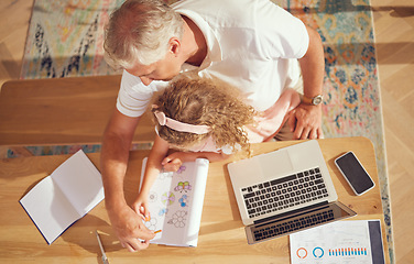 Image showing Top view, old man and girl learning drawing while her grandfather is busy with paperwork in family home office. Senior grandfather helping and teaching a creative child to color in a school project