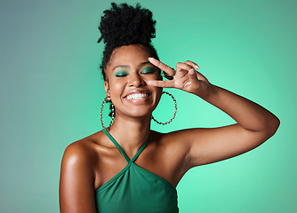 Image showing Peace sign hand, fashion and black woman on green studio background mockup with cosmetics and a bright smile. Happy african Kenya girl or model with color cosmetics and v sign for youth lifestyle