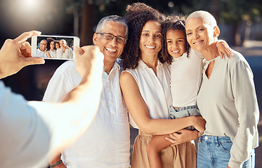 Image showing Phone, screen and happy family relax and smile while posing for a picture outdoors together, loving and embracing. Child, mother and grandparents bonding on a trip in nature, hug and enjoy summer