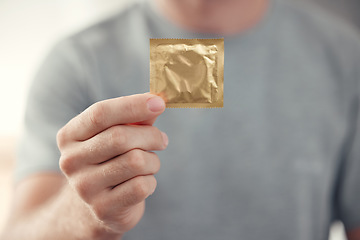 Image showing Condom in man hand for safe sex, sexual safety and hiv awareness zoom. Person with male contraceptive product for sexual risk prevention, healthcare and caution for security, trust and love choice