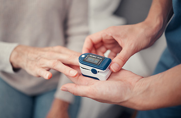 Image showing Hands, patient and finger pulse with nurse to monitor oxygen, rate and health at home. Closeup hand of caregiver helping elderly person in oximetry healthcare to check pulses or monitoring breathing
