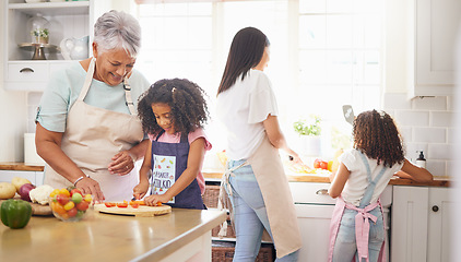 Image showing Black family cooking, children learning and grandmother teaching girl for healthy lunch and growth development in kitchen together. Senior woman and mom with kids make salad or vegetable food in home