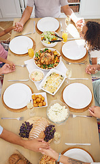 Image showing Pray, food and family friends dinner at a table with gratitude, love and religion faith before eating. Praying at a meal as a spiritual and christian practice holding hands together for worship