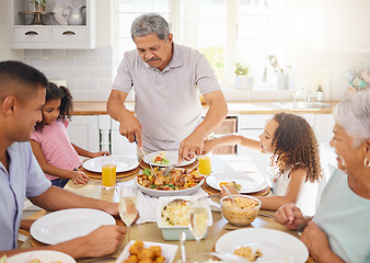 Image showing Family lunch, home celebration and grandparents hosting a dinner at kitchen table for children with turkey chicken. Girl kids, father and senior people eating food together with love in their house