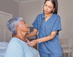 Image showing Doctor, stethoscope and senior woman with caregiver checking health, heart rate and beat at home. Young female healthcare GP or nurse helping elderly patient check heartbeat for medical care indoors
