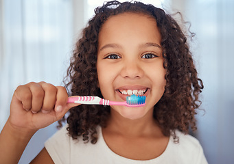 Image showing Girl, brush and smile with teeth for dental, care and clean hygiene in fresh oral healthcare at home. Portrait of a happy female child, face and toothbrush smiling in bathroom for morning routine